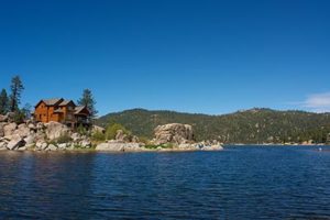 A log cabin on a mountain lake.
